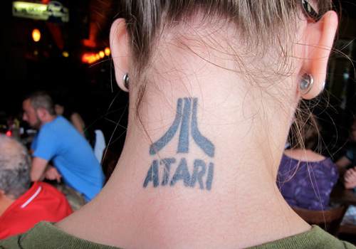 Atari Name Tattoo On Girl Back Neck