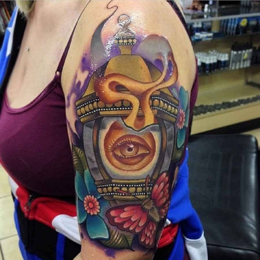 Beautiful Eye Lamp Tattoo On Left Half Sleeve by Mike Petroskie