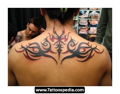 Black And Red Tribal Design Tattoo On Upper Back