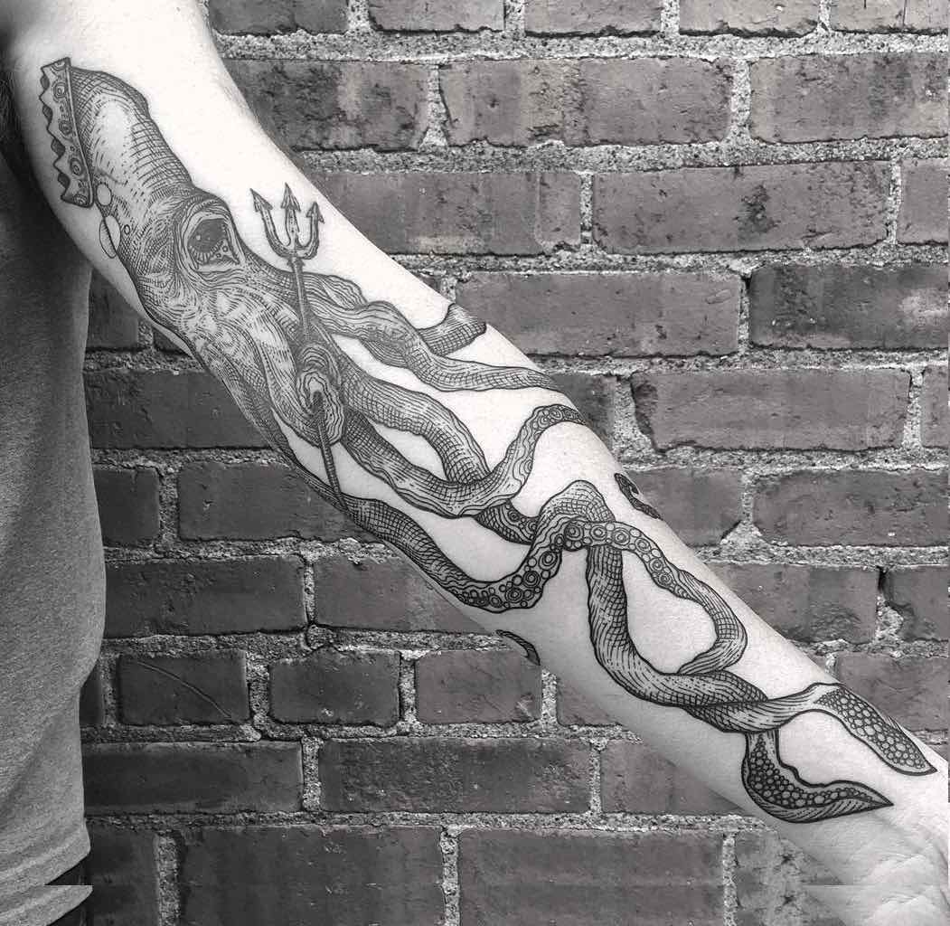 Black And White Squid With Trident Tattoo On Left Forearm