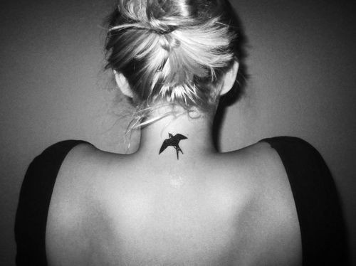 Black Flying Bird Tattoo On Women Back Neck