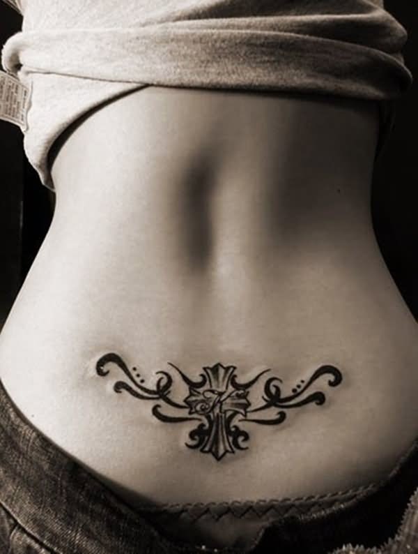 Black Ink Cross With Tribal Design Tattoo On Lower Back