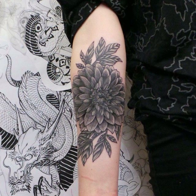 Black Ink Dahlia Flower Tattoo On Forearm