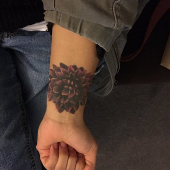Black Ink Dahlia Flower Tattoo On Wrist