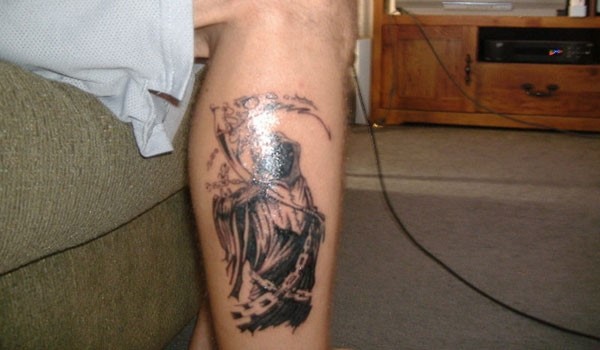 Black Ink Grim Reaper Tattoo On Right Leg Calf
