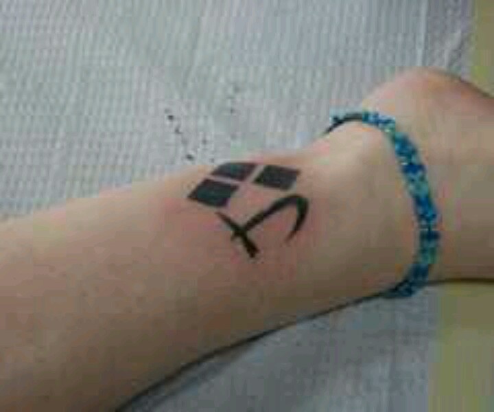 Black Ink Harley Quinn Symbols Tattoo On Leg