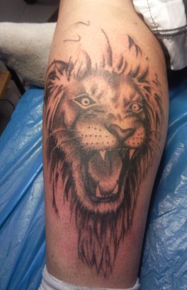 Black Ink Lion Head Tattoo Design For Leg Calf