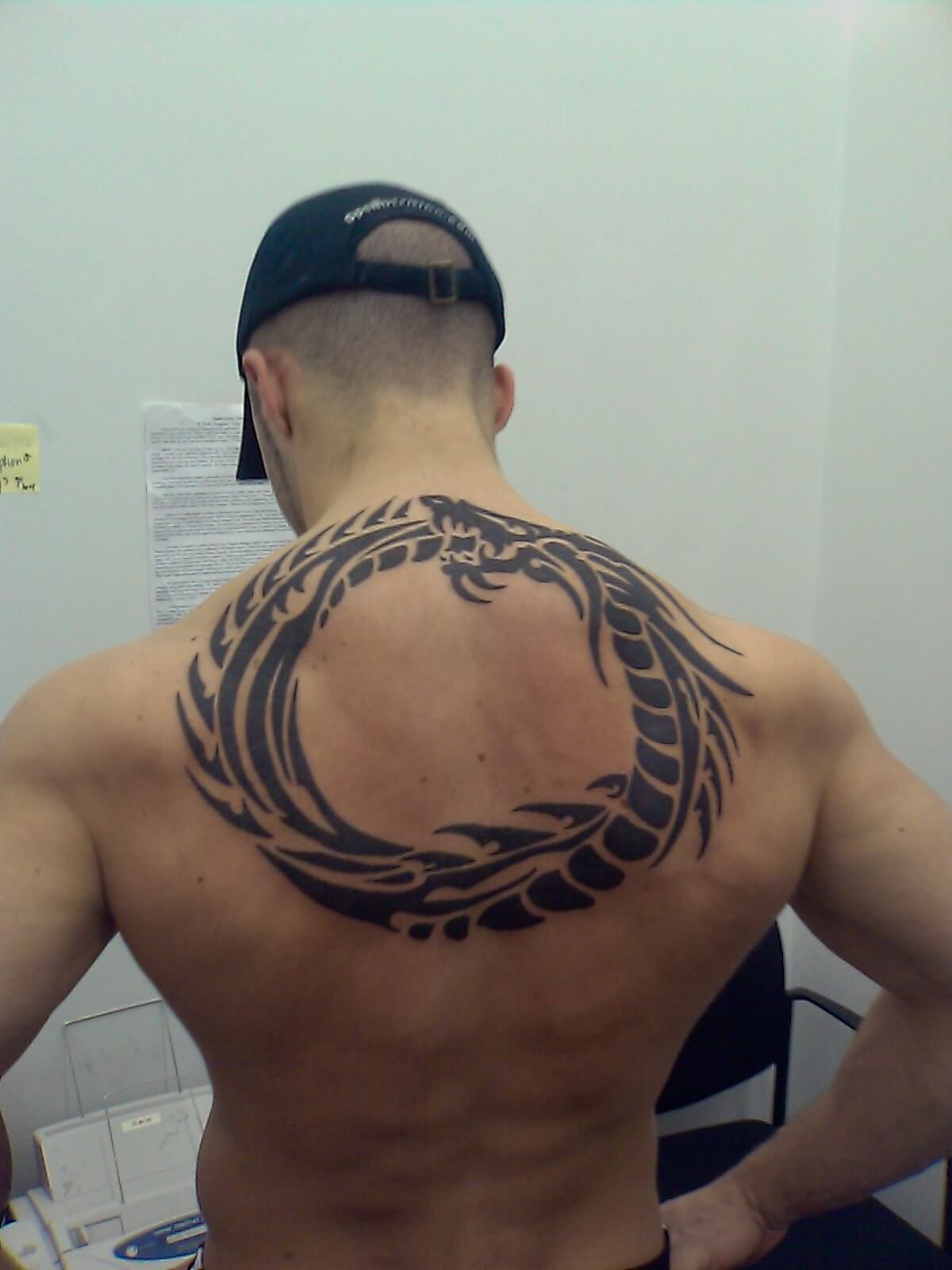 Black Ouroboros Tattoo On Man Upper Back