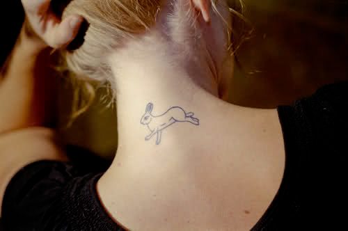 Black Outline Rabbit Tattoo On Girl Back Neck