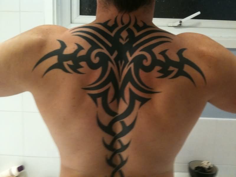 Black Tribal Design Tattoo On Man Upper Back