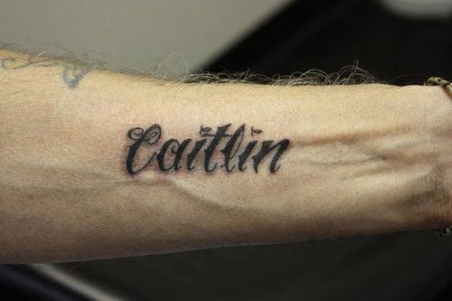 Caitlin Name Tattoo On Left Forearm