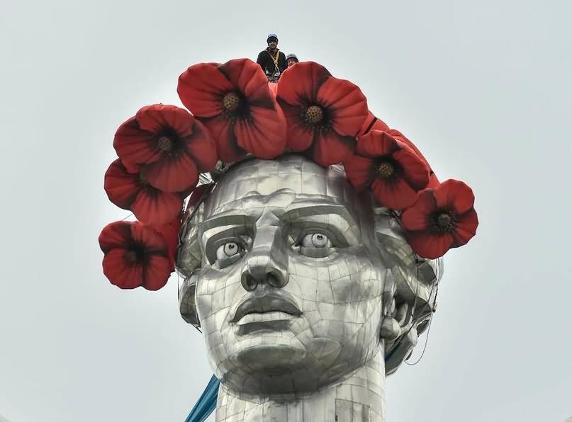 Closeup Of The Face Of The Mother Motherland Monument With Red Poppies Wreath