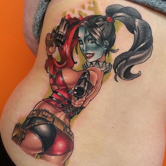 Colored Harley Quinn With Guns Tattoo On Back