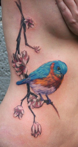 Colored Sparrow Tattoo On Girl Side Rib