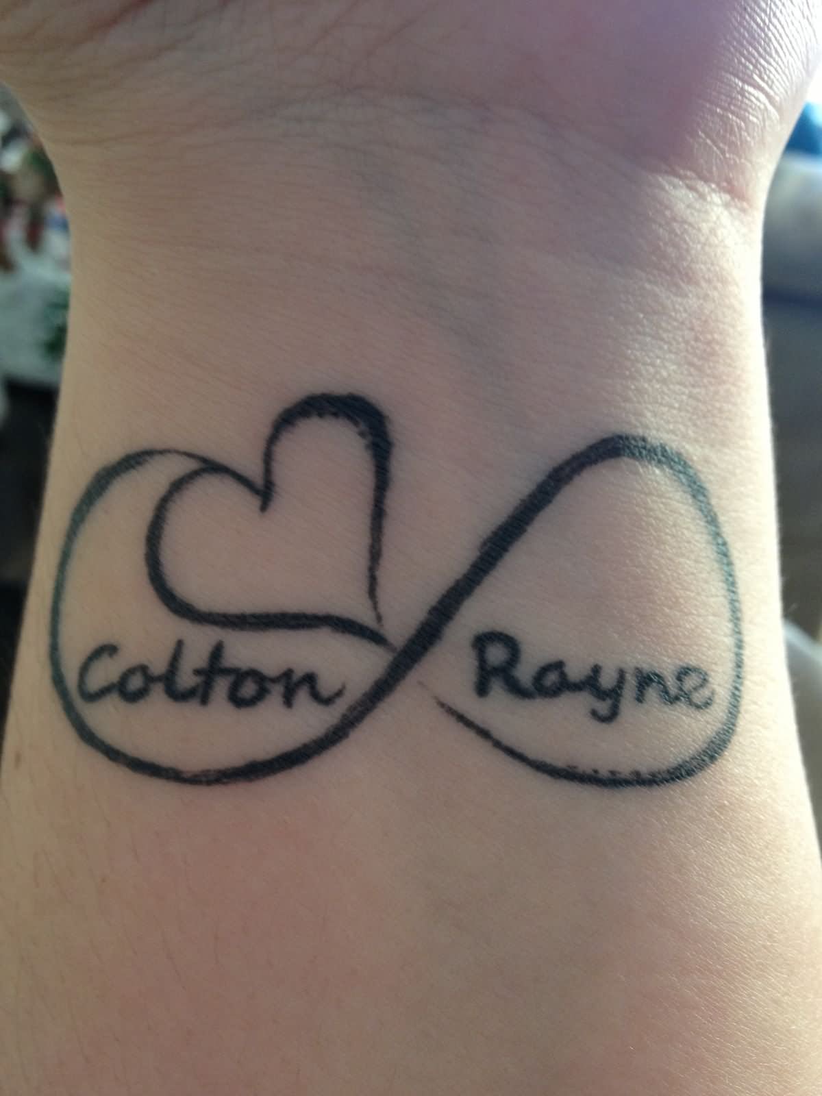 Colton Rayne Name With Infinity And Heart Tattoo On Wrist