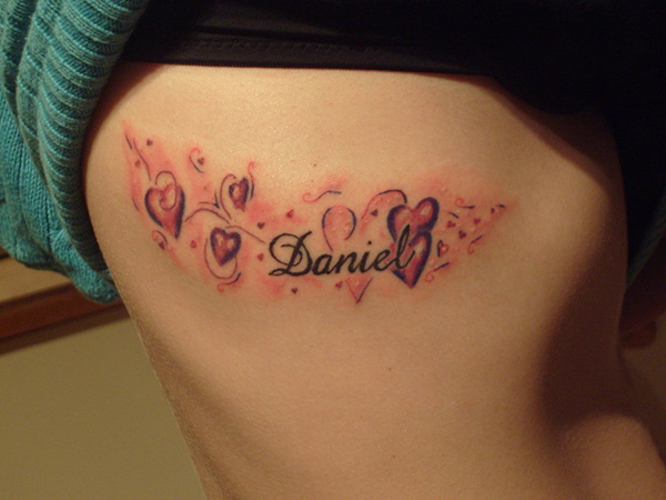Daniel Name With Hearts Tattoo On Right Side Rib
