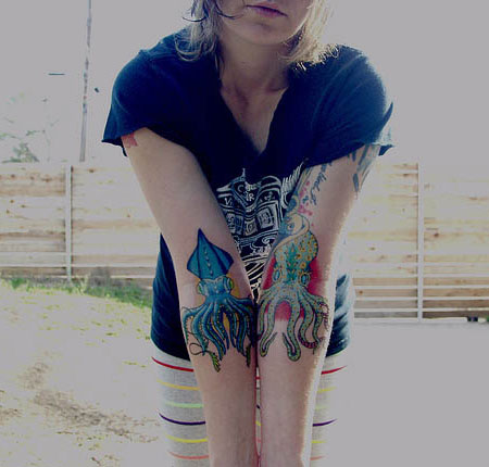 Girl Showing Squid Tattoos On Both Arm