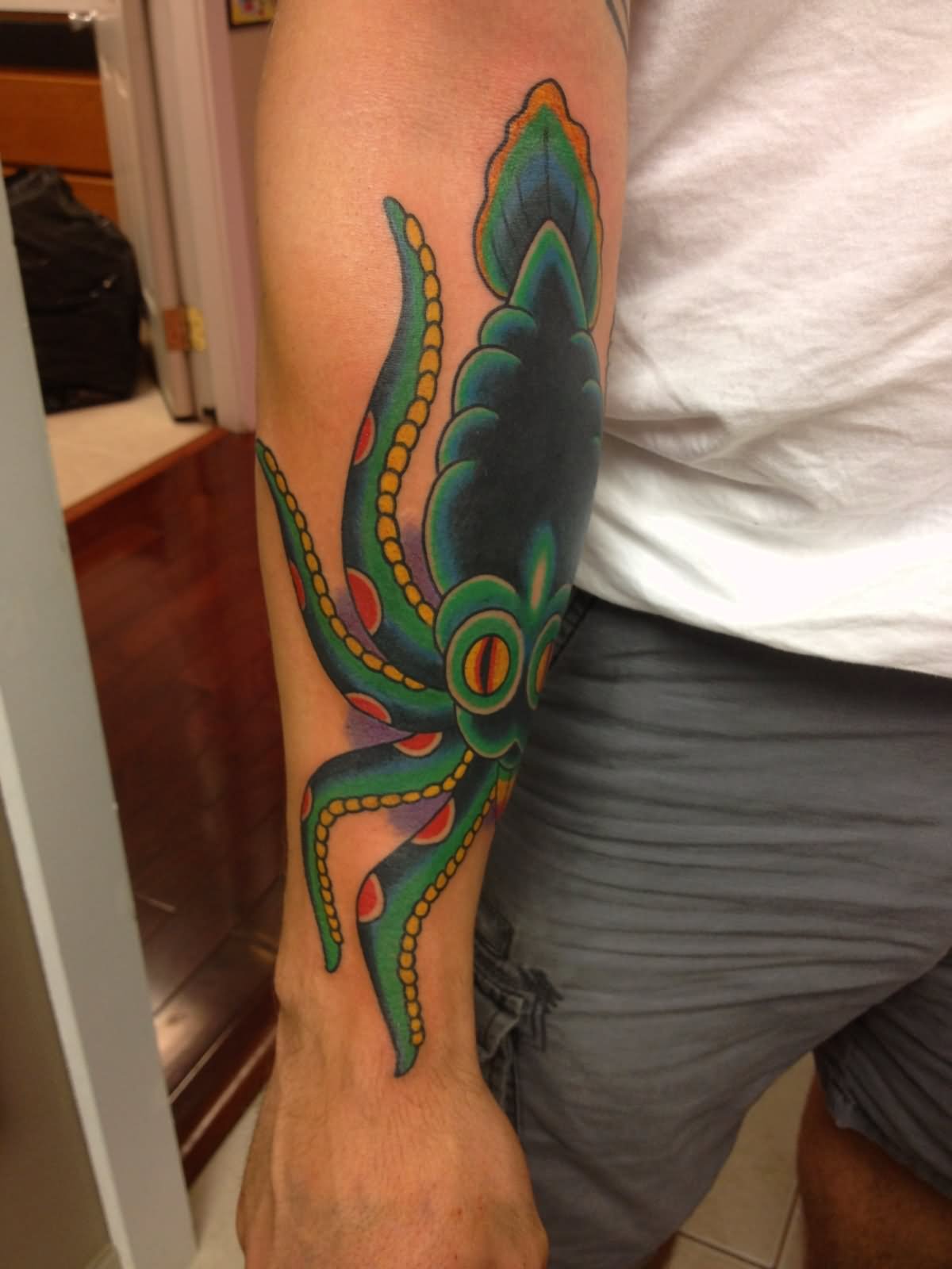 Green Ink Squid Tattoo On Right Arm