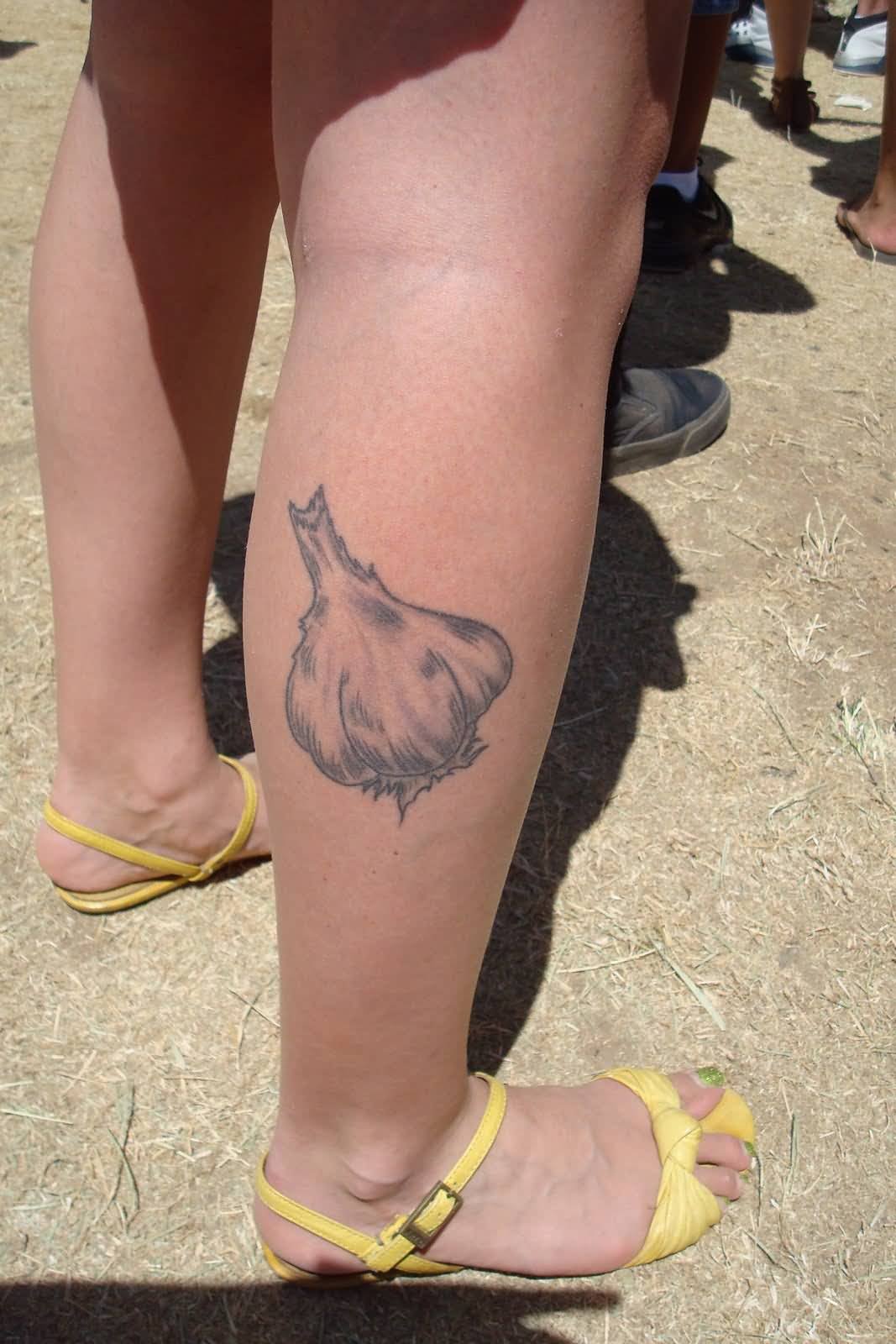 Grey Ink Garlic Tattoo On Girl Right Leg Calf