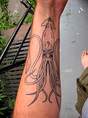 Grey Ink Squid Tattoo On Left Forearm