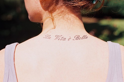 La Vita E Bella Lettering Tattoo On Girl Back Neck