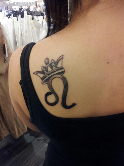 Leo Symbol With Crown Tattoo On Women Left Back Shoulder