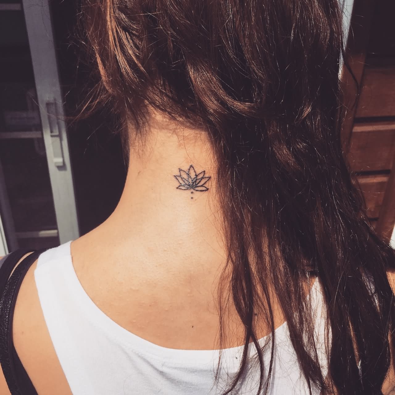 Little Black Outline Flower Tattoo On Women Back Neck