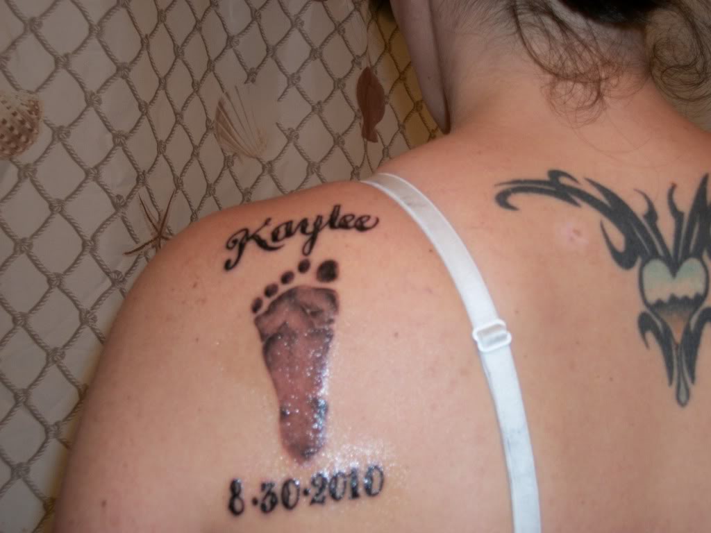Memorial Kaylee Name With Foot Print Tattoo On Left Back Shoulder
