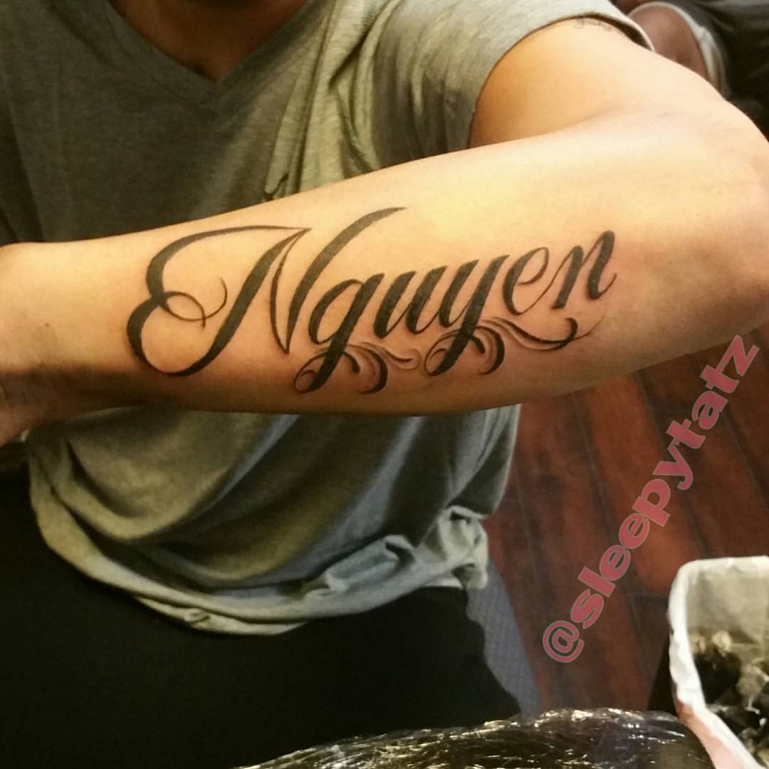 Nguyen Name Tattoo On Left Arm