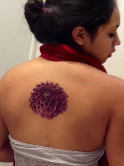 Purple Ink Dahlia Flower Tattoo On Girl Upper Back