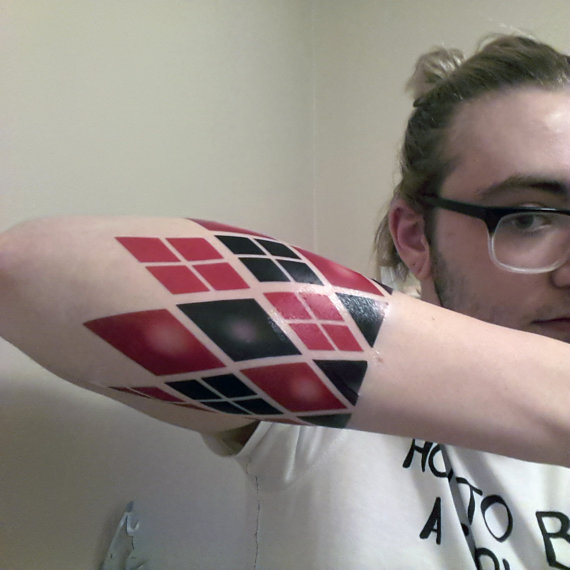 Red And Black Diamonds Harley Quinn Tattoo On Right Sleeve