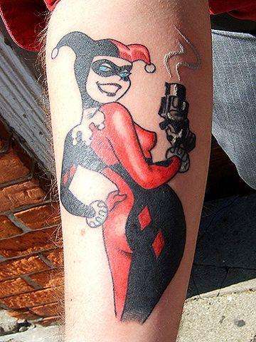 Red And Black Ink Harley Quinn Tattoo On Right Arm