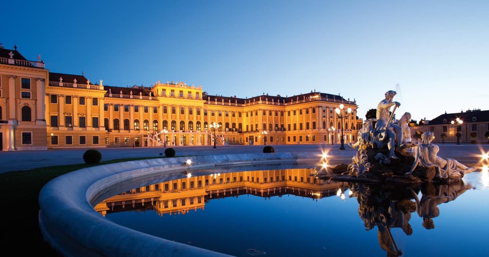 Side View Of The Schonbrunn Palace Lit Up At Dusk