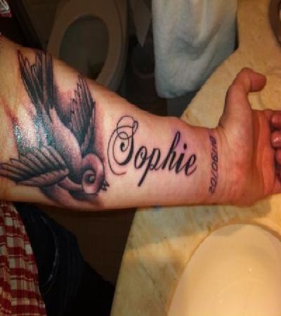 Sophie Name With Flying Bird Tattoo On Left Forearm