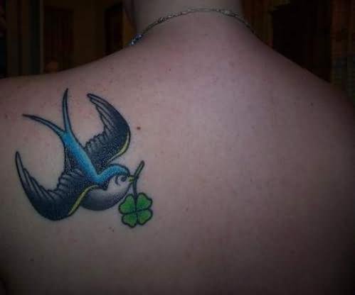 Sparrow With Clover Leaf In Beak Tattoo On Back Shoulder