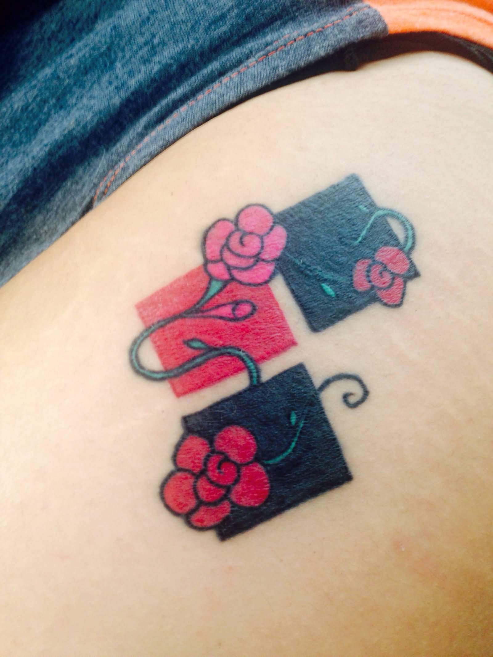 Traditional Harley Quinn Symbol With Flowers Tattoo