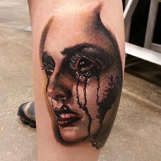 Unique Crying Girl Face Tattoo On Left Leg Calf
