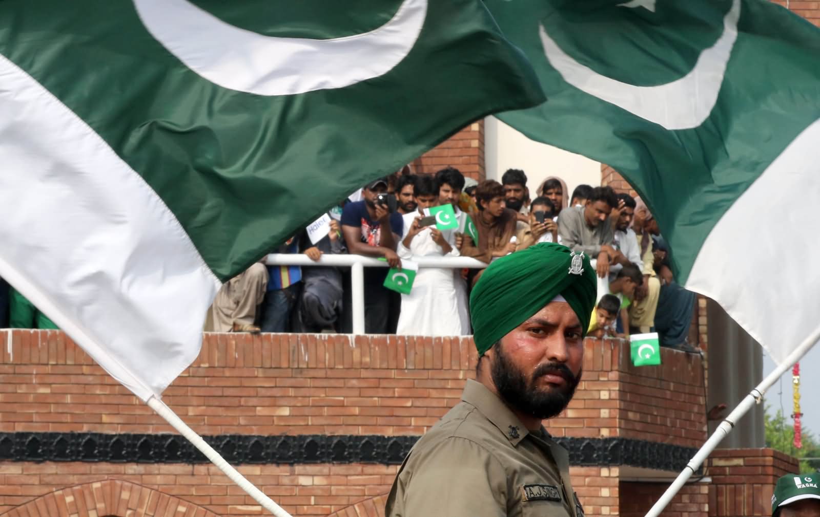 A Pakistani Sikh Border Ranger Waves The Flag During The Celebrations Of Pakistan's Independence Day