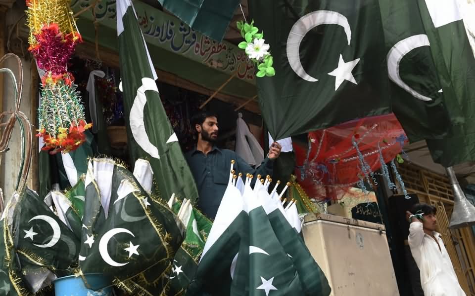 A Shopkeeper Selling Pakistani Flags During The Celebrations Of Independence Day