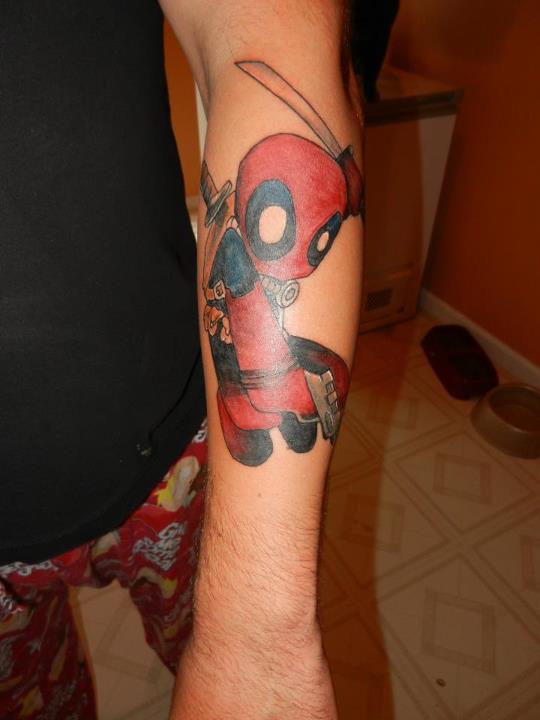 Amazing Baby Deadpool Tattoo On Left Arm By Rizzi