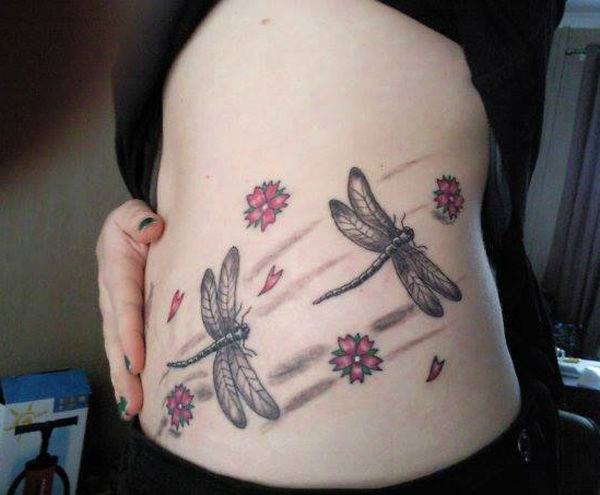 Amazing Flower And Grey Dragonfly Tattoo On Side Rib