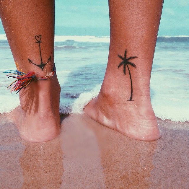 Anchor And Palm Tree Tattoos On Both Legs