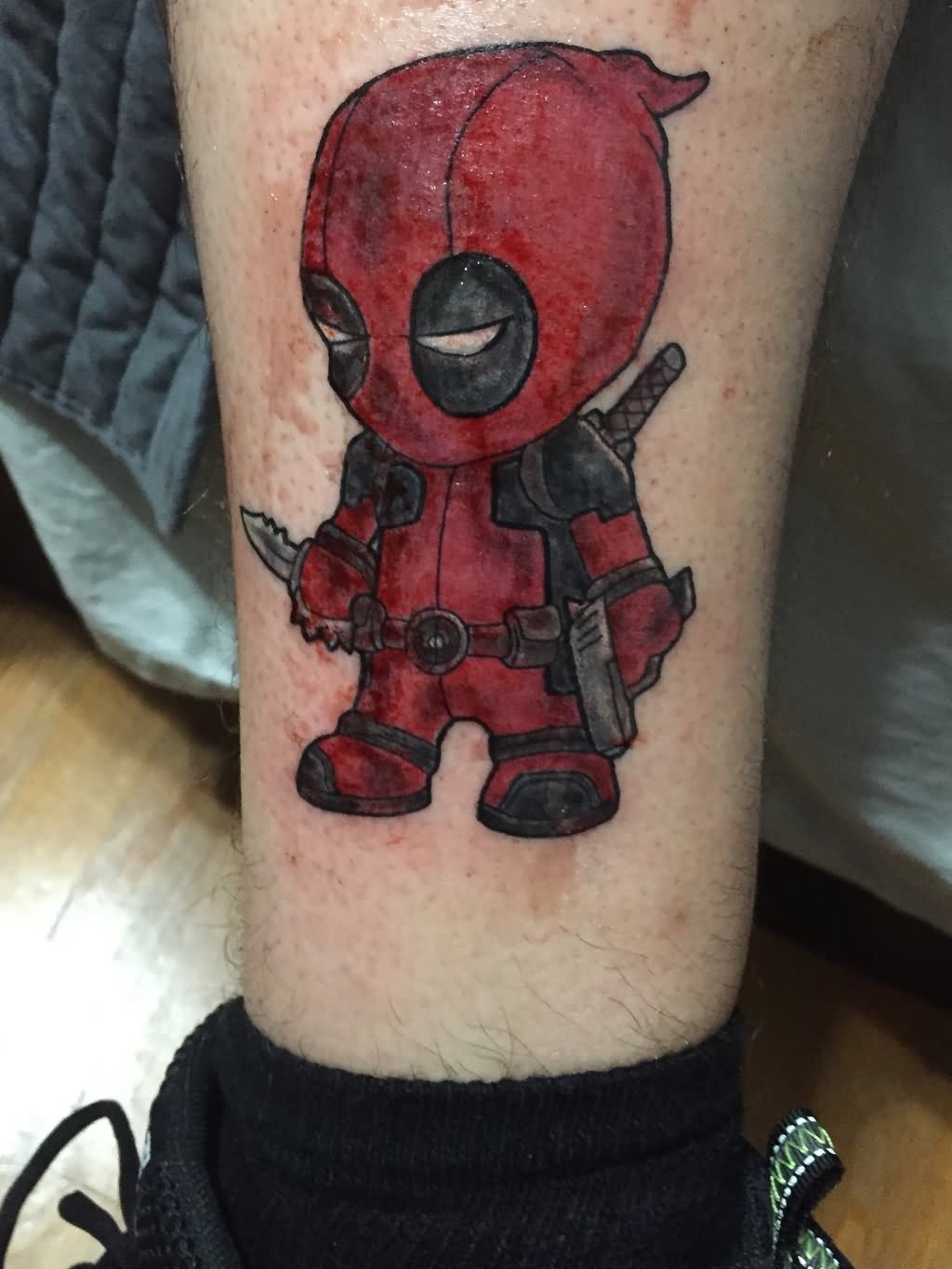 Baby Deadpool Tattoo On Leg By Shane Wasserman