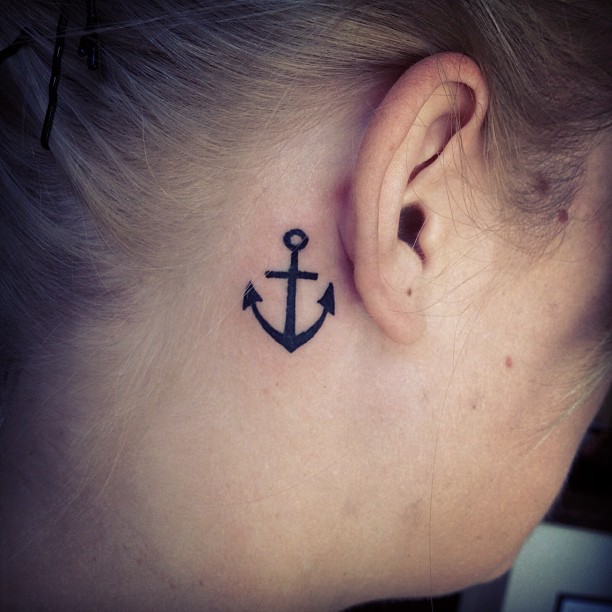 Black Anchor Tattoo On Girl Right Behind The Ear