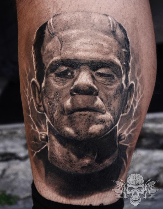 Black And Grey Frankenstein Head Tattoo Design For Leg Calf