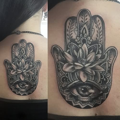Black And Grey Hamsa With Flower Tattoo On Girl Upper Back