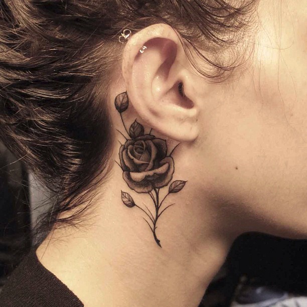 Black And Grey Rose Tattoo On Girl Right Behind The Ear