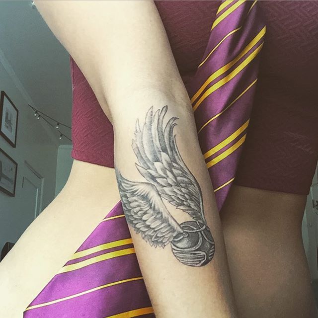 Black And Grey Snitch Tattoo Design For Arm