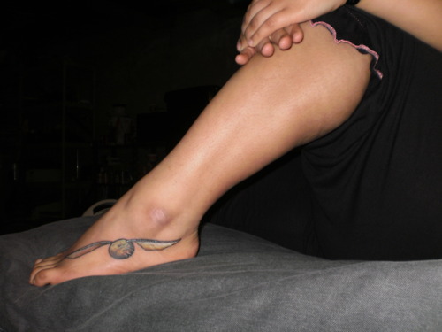 Black And Grey Snitch Tattoo On Right Foot