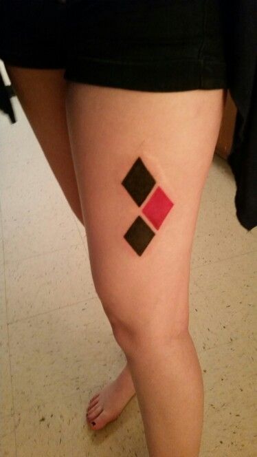 Black And Red Ink Harley Quinn Symbol Tattoo On Left Thigh